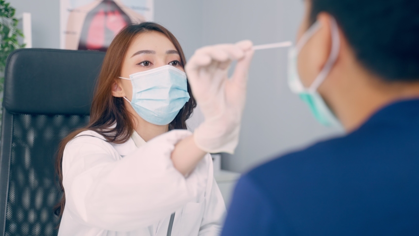 Asian professional specialist doctor diagnosis PCR Coronavirus sample. Young female physician use a rapid antigen test doing quick swab for patient during Covid pandemic in medical laboratory hospital Royalty-Free Stock Footage #1087305818