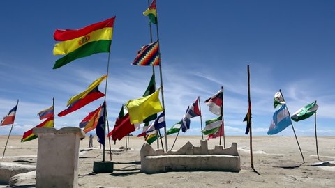 Flags of countries in Dakar Rally flying in the wind at Salar de Uyuni, Bolivia