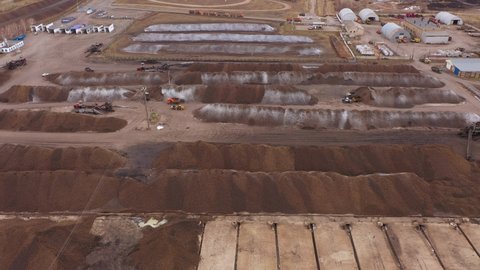 The process of unloading sugar beets. Heap of licorice. The movement of trucks with trailers. Aerial view.