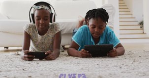Animation of p1 vs p2 text with african american children using tablet and smartphone. retro communication and video games concept digitally generated video.