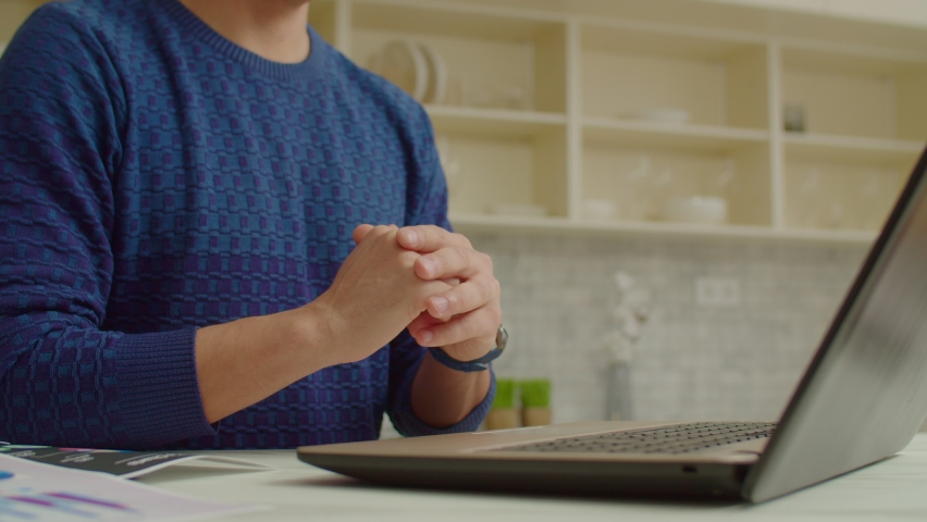 Close-up of deaf man talking with sign language, communicating with friends online via video conference call while relaxing in domestic kitchen. Royalty-Free Stock Footage #1087333238