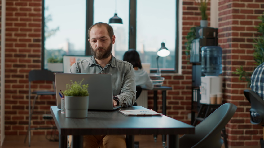 Portrait of cheerful man pointing at speech bubble with hiring ad, making job and employment offer. Positive male recruiter advertising HR work application opportunity with text message.