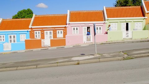 Willemstad , Curaçao - 01 04 2022: Pastel coloured houses on the quaint Berg Altena Road in Willemstad