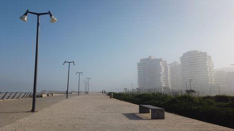 Casablanca, Morocco - 10 February 2022 : view of modern buildings in Marina Casablanca from walk alley in a foggy day