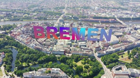 Inscription on video. Bremen, Germany. The historic part of Bremen, the old town. Bremen Cathedral ( St. Petri Dom Bremen ). View in flight. Lightning strikes the letters, Aerial View, Departure of t