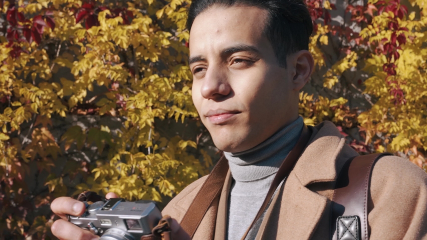 Close-up view of Arabian man taking street photos