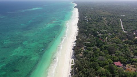 Diani beach Kenyan coast African Sea drone aerial 4k waves blue indan ocean tropical mombasa turquoise white sand East Africa palms paradise view Kenya landscape 