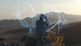 The concept of mental health preservation. A man sits on top of a cliff at sunset and tries to organize his thoughts. The process of concentration is visualized by means of computer graphics