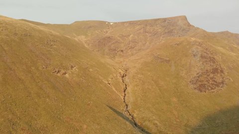 Lake District. Cumbria. April. 16. 2022. England. Flying away from Blencathra Mountain drone footage
