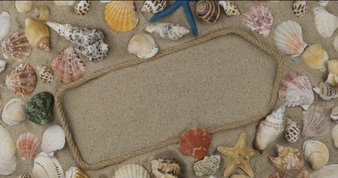 Pointer, arrow made of rope lying among shells, stars on the sand. Copy space. With space for design, text place. Top view