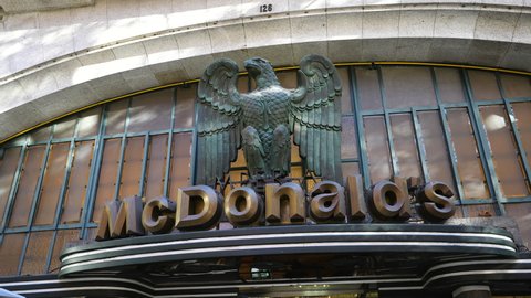 Portugal, 2021: Stylized Mcdonald's restaurant logo. Entrance to mac cafe shop center exterior design. Preserving old fashion architecture achievements past. Example mcdonalds brand integrating.
