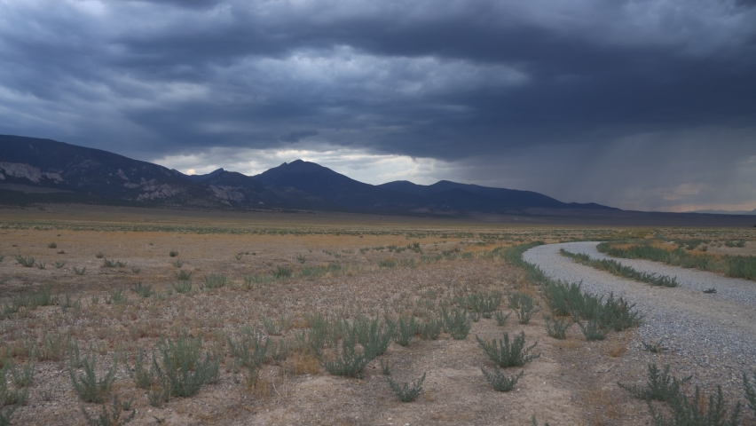 Rainclouds gather over Great Basin National Park and the Snake Mountain Range near Baker, Nevada. Time-lapse of the storm sweeping through and darkening the sky.