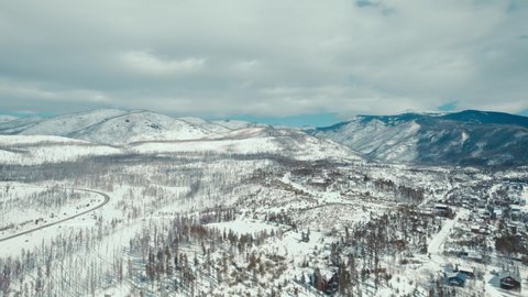 Grand Lake, Colorado. Drone Aerial View Of Small Snow-Covered Winter Town During Daylight Near Alpine Forest After Wildfires.
