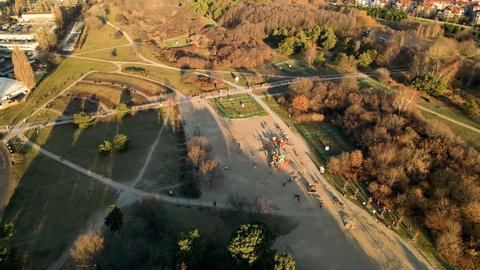 Children playing at public playground at sunset in Ronald Reagan Park, Gdansk, Poland - aerial top view 