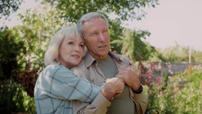 Romantic Senior Couple Relaxing Outdoors In Garden, Embracing And Talking, Happy Dreamy Elderly Spouses Spending Time Together At Countryside, Enjoying Retirement, Closeup, Slow Motion Footage - Powered by Shutterstock - Get 15% off with code: PIKWIZARD15