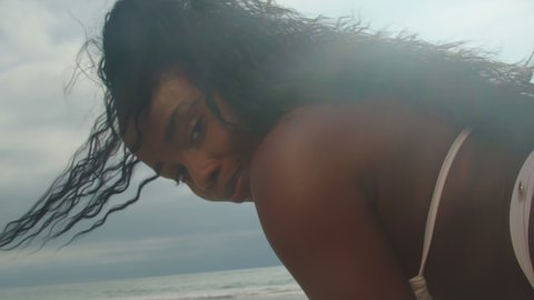 Portrait of a sexy dark-skinned girl in a bikini beautiful female ass on the beach in summer. Slow Motion