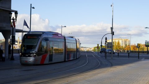 Zaragoza, Spain - November 30, 2019: Tram passing in Zaragoza city center with people walking by, in Spain