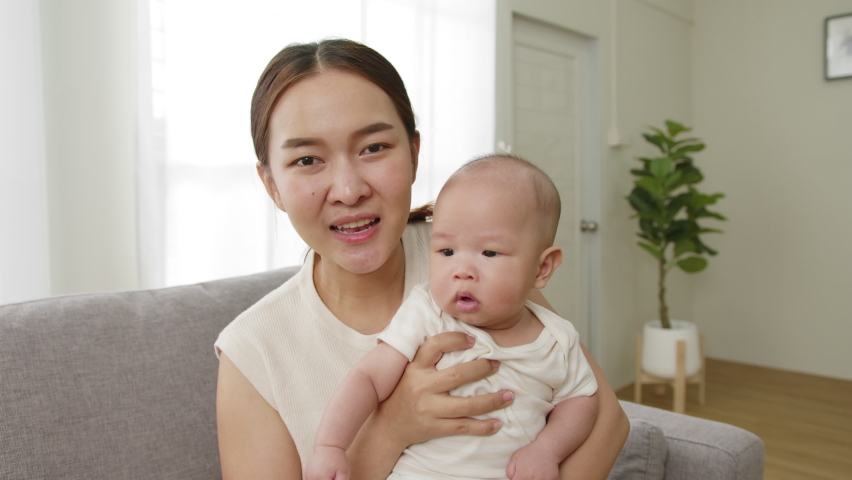 Point of view, Young Asian mother and her newborn baby smiling and say hello, goodbye via video call or facetime feeling happy Royalty-Free Stock Footage #1087388279