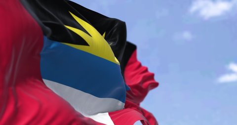 Detail of the national flag of Antigua and Barbuda waving in the wind on a clear day. Antigua and Barbuda is a sovereign island country in the West Indies in the Americas. Selective focus. Seamless lo