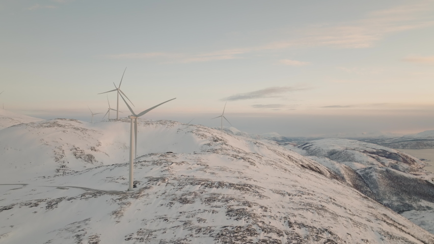 Aerial of Wind turbine on snow mountain. Renewable and clean energy.Wind energy.