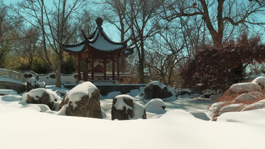 Slow pan left of fresh snow with red Chinese pavilion in background - Powered by Shutterstock - Get 15% off with code: PIKWIZARD15