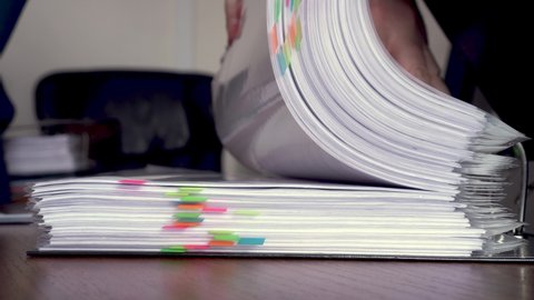 folder with documents with bright stickers. selective focus. Turning pages. Work in the office.