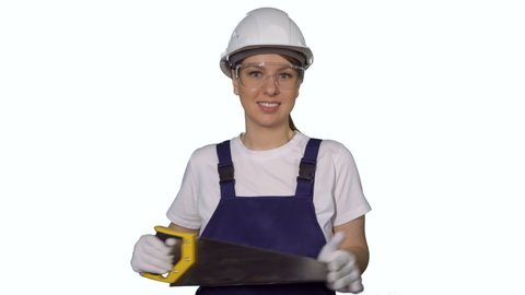 Construction worker. Woman builder in blue overalls and white hard hat hold hand saw. Building, repair and renovation of house or apartment. Female in helmet on white isolated background.