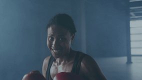 Animation of interference over african american female boxer punching at gym. global sports, healthy lifestyle and digital interface concept digitally generated video.