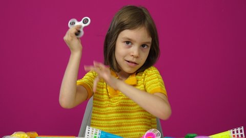 The blogger girl tells and shows her new fidget spinners toys. Social media concept.