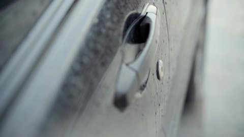Kiev, Ukraine - January 12,2022: Subaru car door opening with key in rainy weather. High quality 4k footage