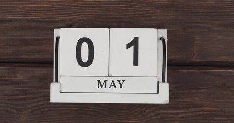 May calendar, change of days. wood calendar with date month and day on a wooden table. fast pace of time during the month. accelerated calendar. Stop motion. 