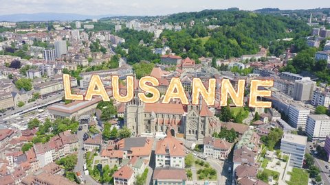 Inscription on video. Lausanne, Switzerland. Cathedral of Lausanne. La Cite is a district historical centre. Heat burns text, Aerial View, Departure of the camera