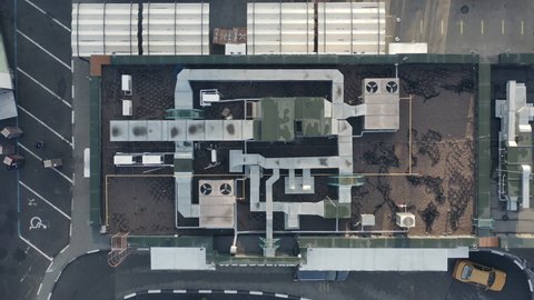 Top view fast food restaurant: drone shot with cooling ventilation system on the roof of fast food restaurant. Climate Control on restaurant roof - aerial drone zoom out shot.