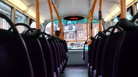 Inside of upper deck of double-decker bus driving in high street in Eccles town, Salford city, England.