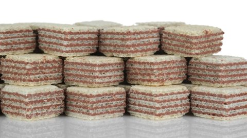 Square wafer biscuits isolated on white background, Sliding shot. Cocoa wafers. 4K UHD footage.