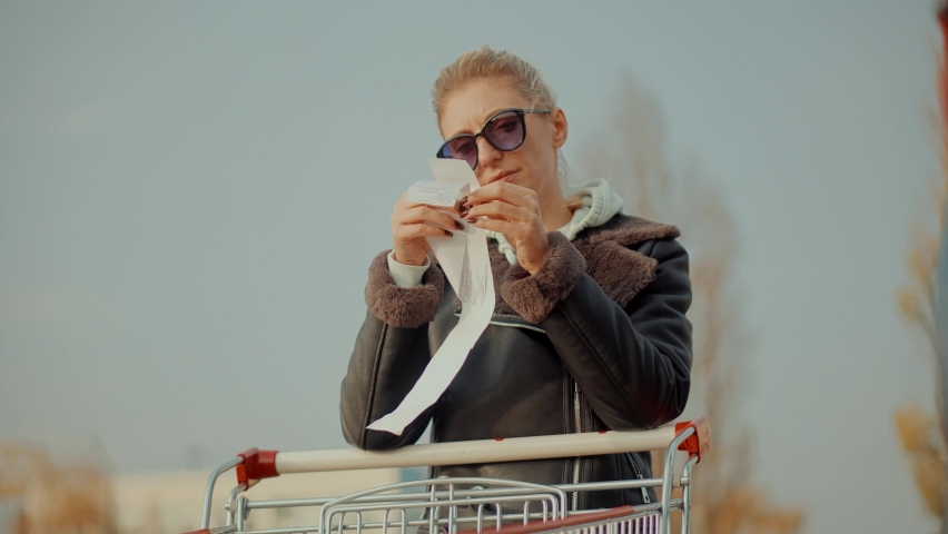 Buyer Checks Paper Receipt On Shopping Supermarket. Customer Receipt Bill Expensive Total. Cash Register Money Spending On Hypermarket. Home Finance Budget.Woman Check Bill Grocery Store Shopping Cart Royalty-Free Stock Footage #1087420805