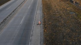 Overhead shot of an African-American woman warming up on the side of the road to start running.