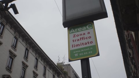 
Milan, Italy - February 18, 2022: the entrance gate with the sign and the entrance cameras to the restricted traffic area of ​​Milan. Written in Italian: "Area C Limited traffic zone".