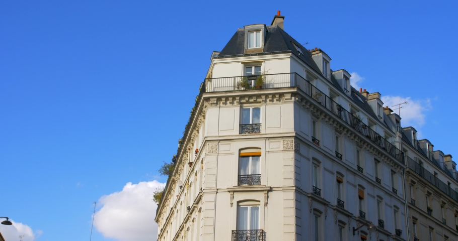 Typical Haussmannian Architecture after Haussmann's renovation of Paris. Parisian Building In France - low angle with blue sky in background. | Shutterstock HD Video #1087425725