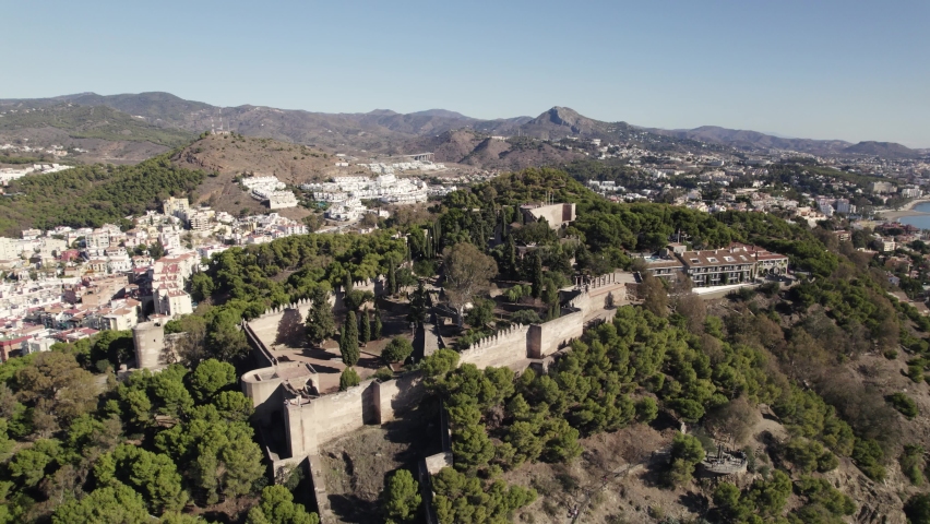 Aerial orbiting Gilbralfaro Castle on Hilltop, with panoramic views over Malaga Coastline. Spain