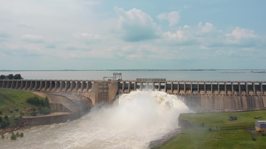 Revealing shot of lake behind reservoir wall with open sluice gates. Vaal dam, South Africa Royalty-Free Stock Footage #1087432142
