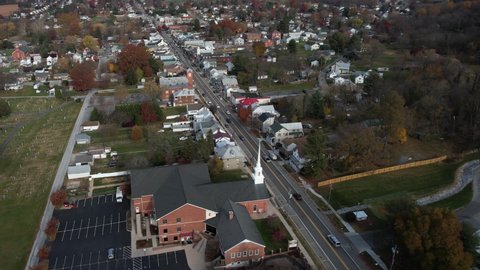 Boonsboro Maryland USA. Aerial View of Main Street Traffic and Mount Nebo United Methodist Church in Autumn Season, Drone Shot