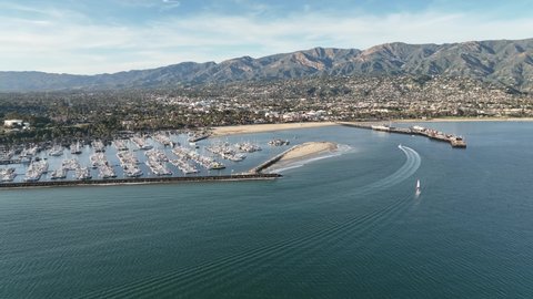 Santa Barbara California Harbor pier, aerial drone. Flying Along the Santa Barbara, California Coastline and Ocean.