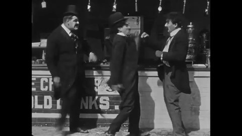 CIRCA 1915 - In this silent comedy, a man (Charlie Chaplin) starts a fight with another outside an ice cream stand.