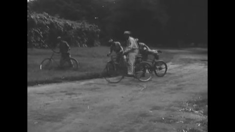 CIRCA 1945 - African-American soldiers unload bicycles from an army truck and ride them through the countryside of Calcutta.