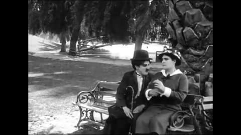 CIRCA 1914 - In this silent comedy, a man (Charlie Chaplin) confides his marital problems in a stranger at a park.
