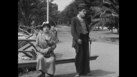 CIRCA 1915 - In this silent comedy, a man (Charlie Chaplin) flirts with a woman while her boyfriend is caught up in a fight.