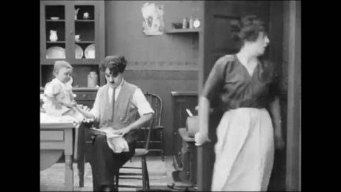 CIRCA 1914 - In this silent comedy, a man (Charlie Chaplin) and his wife argue about taking care of the baby.