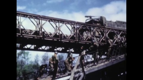 CIRCA 1945 - A convoy of US Army trucks drives over a bridge in Nuremberg, Germany.
