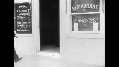 CIRCA 1914 - In this silent comedy, a man (Charlie Chaplin) plays with a man's beard at a restaurant until he leaves his seat.